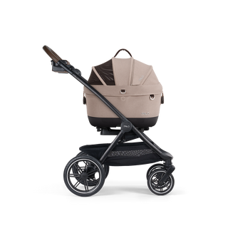 A Maeve iso 5x Pet Car Seat closed, in fawn, and attached to the Roscoe Trek 2.0 Pet Stroller Frame from a side profile