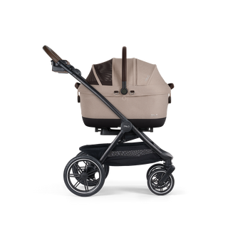 A Maeve iso 6x Pet Car Seat closed, in fawn, and attached to the Roscoe Trek 2.0 Pet Stroller Frame from a side profile