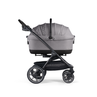 A Maeve iso 7x-R Pet Car Seat closed, in merle, and attached to the Roscoe Trek 2.0 Pet Stroller Frame from a side profile