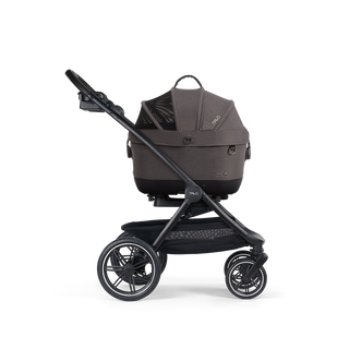 A Maeve iso Wind 5x Pet Car Seat closed, in ashen, sitting next to the Roscoe Trek 2.0 Pet Stroller Frame