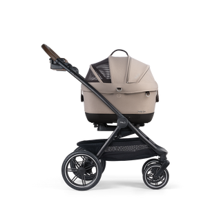A Maeve iso Wind 5x Pet Car Seat closed, in fawn, and attached to the Roscoe Trek 2.0 Pet Stroller Frame from a side profile