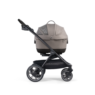 A Maeve iso Wind 5x Pet Car Seat closed, in merle, and attached to the Roscoe Trek 2.0 Pet Stroller Frame from a side profile