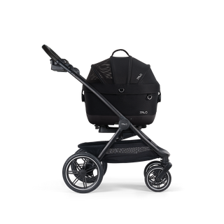A Maeve iso Wind 5x Pet Car Seat closed, in onyx, sitting next to the Roscoe Trek 2.0 Pet Stroller Frame