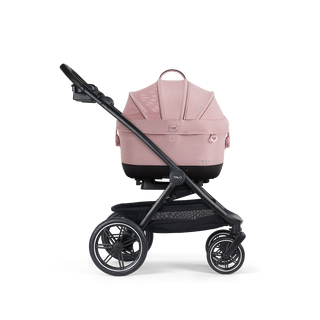 A Maeve iso Wind 5x Pet Car Seat closed, in sakura, sitting next to the Roscoe Trek 2.0 Pet Stroller Frame