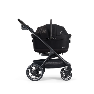 A Maeve iso Wind 6x Pet Car Seat closed, in onyx, and attached to the Roscoe Trek 2.0 Pet Stroller Frame from a side profile