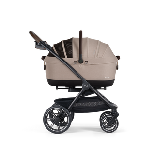 A Maeve iso Wind 7x-L Pet Car Seat closed, in fawn, sitting next to the Roscoe Trek 2.0 Pet Stroller Frame