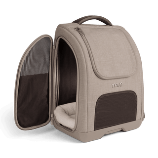A Kamella Pet Backpack and Car Seat, in fawn,with one of the side doors unzipped
