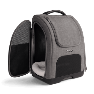 A Kamella Pet Backpack and Car Seat, in flint,with one of the side doors unzipped
