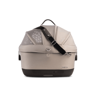 A Maeve iso 5x Wind Pet Car Seat in the fashion tawny from the side with the canopy closed