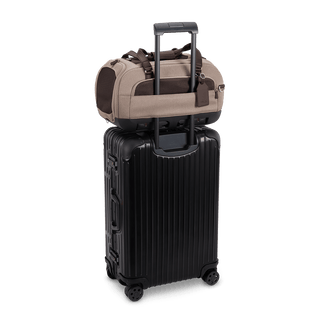 Dupree II pet car seat in the fawn fashion shown on top of luggage using the trolley sleeve