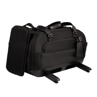 three-quarter view of compact, black pet car seat with two carry handles on top featuring attached side impact protection, extended ISOFIX latches, and black luggage tag