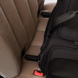 Close up view of ISOFIX latches aimed for the vehicle's rigid latch anchor bars on a brown vehicle seat