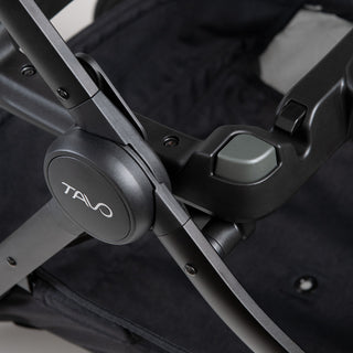 close up of button on pet stroller frame